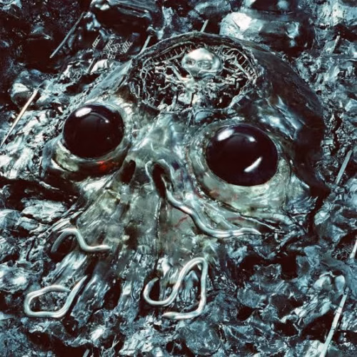 Alien Metal album cover by King Gizzard featuring a dark, metallic creature for CONE's album review.
